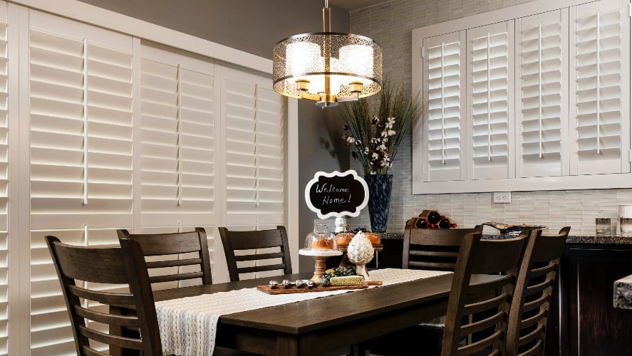 Plantation shutters window treatments in a dining room